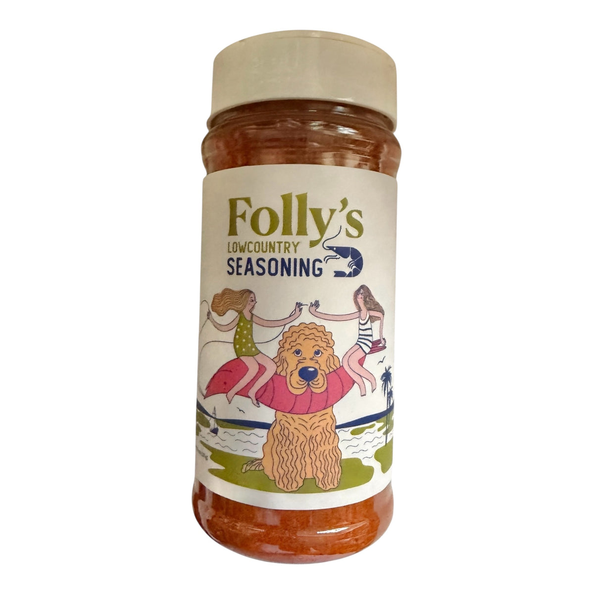 A bottle of Folly's Lowcountry Seasoning with a cream-colored cap and a white label featuring a cartoon illustration of a golden dog and people by the sea.