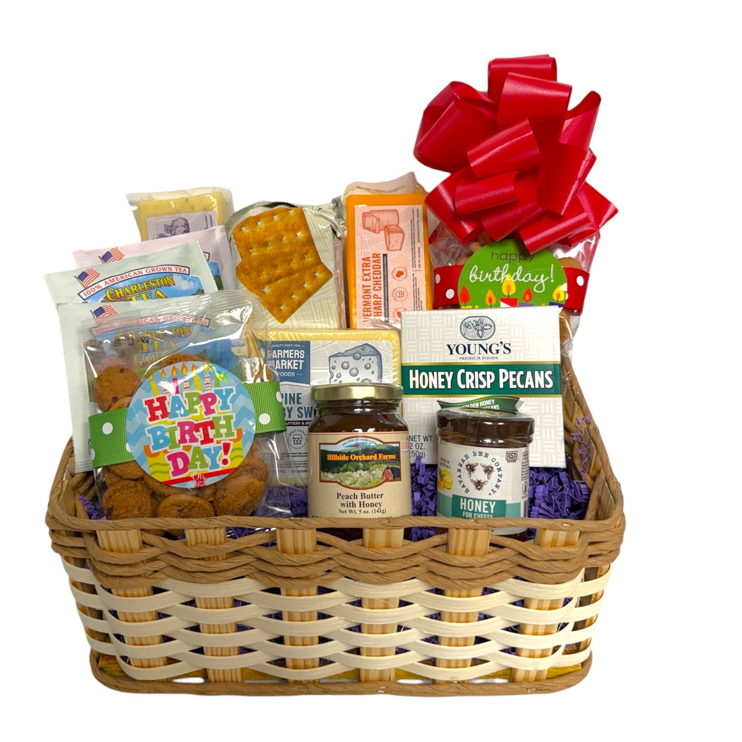 happy birthday gift basket full of cookies, cheese, crackers, tea, honey, and preserves.